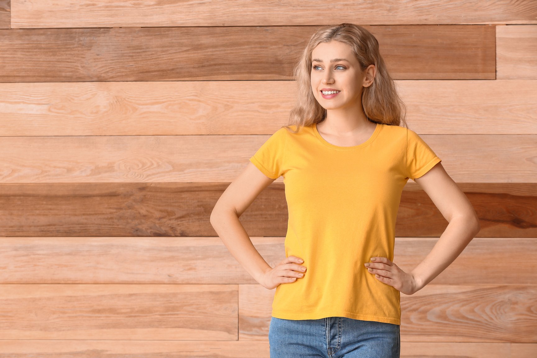 Woman in Yellow T-Shirt on Wooden Background