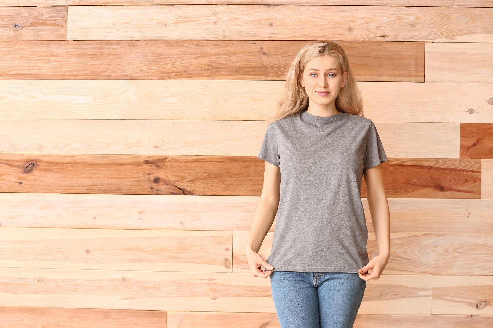 Woman in Grey T-Shirt on Wooden Background