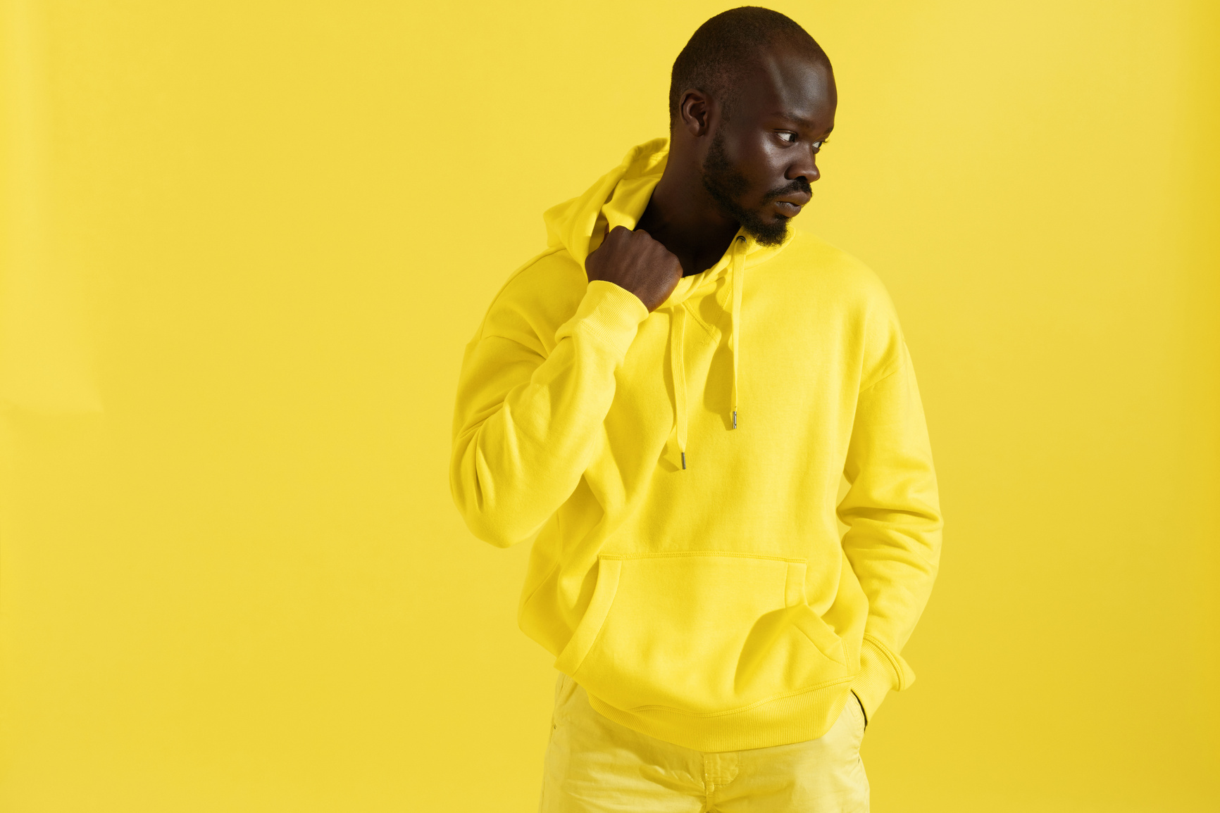 Man in Yellow Hoodie on Yellow Background